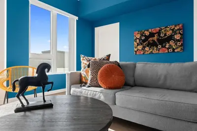 a living room with a couch and a horse statue on a table at Little Tokyo Gem, Steps from Shops with Free Parking in Los Angeles