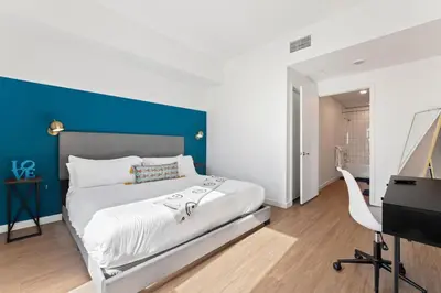 a bedroom with a bed with a blue accent wall at Little Tokyo Gem, Steps from Shops with Free Parking in Los Angeles