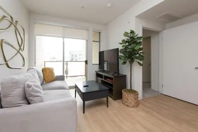 a living room with a white couch and a tv at Walk to Santa Monica Beach Pier Boardwalk Venice in Los Angeles