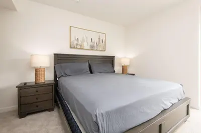 a bedroom with a large bed and two night stands at Walk to Santa Monica Beach Pier Boardwalk Venice in Los Angeles