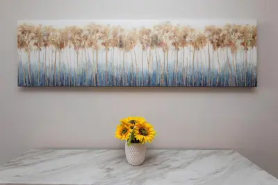 a vase filled with yellow flowers sitting on a table at Stylish 2BR Apt with Rooftop Pool & Hollywood Views in Los Angeles