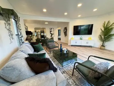 a living room with a couch and a tv at Modern Duplex with 6 beds and Sofa bed in Miracle Mile Longwood in Los Angeles