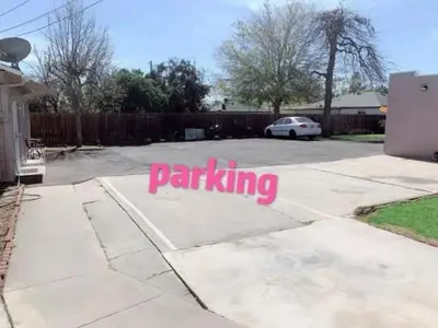 a driveway with the word parking written on it at BACK HOUSE in PASADENA in Pasadena