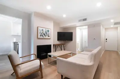 a living room with a couch and chairs and a tv at Stylish 1BR Near Universal Studios with Parking in Los Angeles
