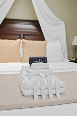 a pile of towels sitting on top of a bed at New Listing Marina Villa by Colby & Conrad in Los Angeles