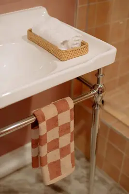 a white bathroom sink with a towel on it at Mane & Saddle Loft in Los Angeles