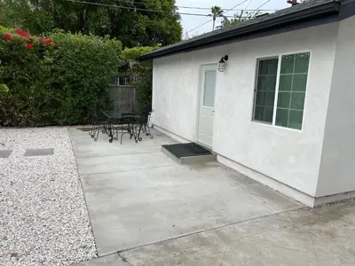 a patio with a table and chairs next to a building at Brand new private one bed one bath home with private parking for 2 in Van Nuys Airport