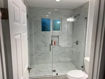 a bathroom with a glass shower with a toilet at Brand new private one bed one bath home with private parking for 2 in Van Nuys Airport