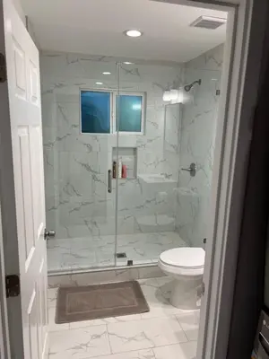 a bathroom with a glass shower with a toilet at Brand new private one bed one bath home with private parking for 2 in Van Nuys Airport
