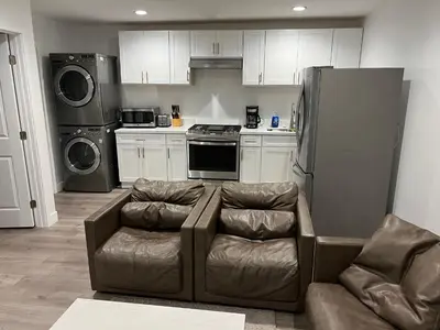 a living room with a couch and a refrigerator at Brand new private one bed one bath home with private parking for 2 in Van Nuys Airport