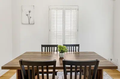a dining room with a wooden table and chairs at Adorable Pasadena Bungalow in Pasadena