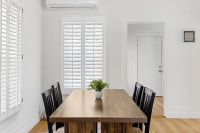 a dining room with a wooden table and chairs at Adorable Pasadena Bungalow in Pasadena