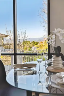 a dining table with a view of a balcony at Quiet Home with Spectacular Scenic Mountain Views near Universal Studios Hollywood in Los Angeles