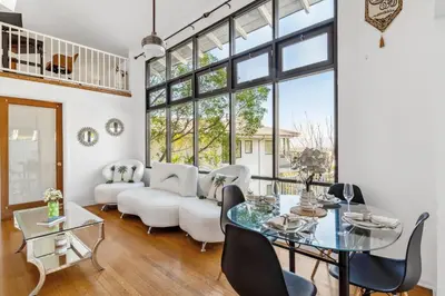 a living room with white furniture and large windows at Quiet Home with Spectacular Scenic Mountain Views near Universal Studios Hollywood in Los Angeles