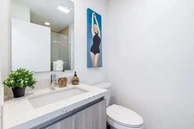 a bathroom with a sink and a toilet and a mirror at Sunset Boulevard Apartments in Los Angeles