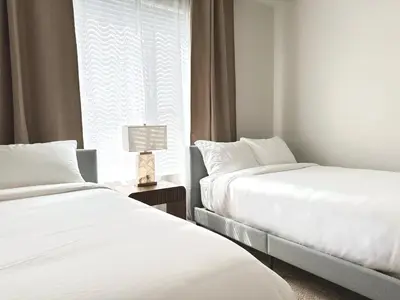 two beds in a hotel room with a window at The Hideaway in MDR, FREE Parking, Heated Pool in Los Angeles