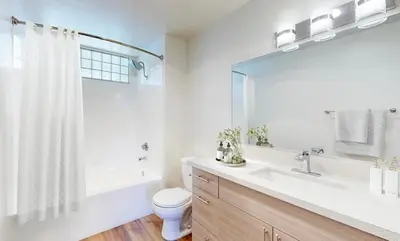 a bathroom with a sink and a toilet and a mirror at The Hideaway in MDR, FREE Parking, Heated Pool in Los Angeles