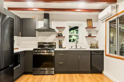 a kitchen with a stove and a sink at Cute Romantic Cabin With Hot Tub 5 Min from Lake in Crestline