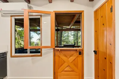 a door in a tiny house with windows at Cute Romantic Cabin With Hot Tub 5 Min from Lake in Crestline