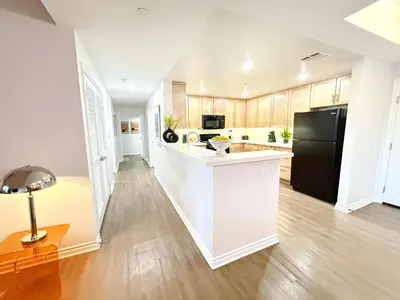 a kitchen with white cabinets and a black refrigerator at 3BR Retreat in Prime Valley Location 109 in Encino