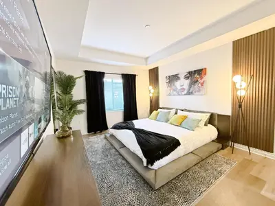 a bedroom with a large bed and a tv at 3BR Retreat in Prime Valley Location 109 in Encino