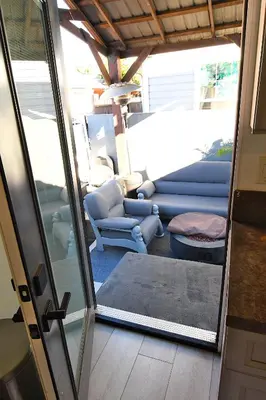 a living room with blue furniture and a sliding glass door at Urban Oasis in Los Angeles
