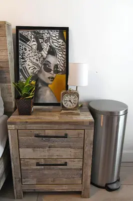 a nightstand with a clock and a picture of a woman at Urban Oasis in Los Angeles