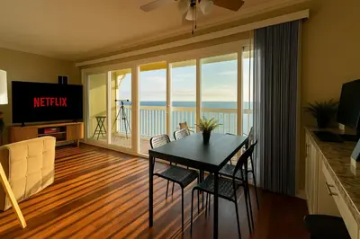 a dining room with a table and a view of the ocean at Ocean Haven Beachfront Getaway by Redondo Pier in Redondo Beach