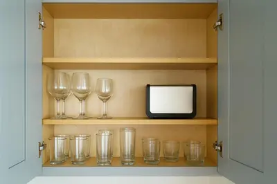 a shelf with wine glasses and a tv on it at Ocean Haven Beachfront Getaway by Redondo Pier in Redondo Beach