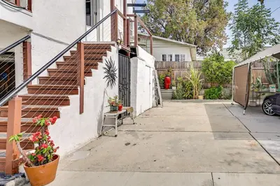 a stairway leading to a house with a fence at Fullerton Home Base Easy Access to Dtwn and CSUF! in Fullerton