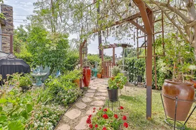 a garden with a pergola with flowers and plants at Fullerton Home Base Easy Access to Dtwn and CSUF! in Fullerton