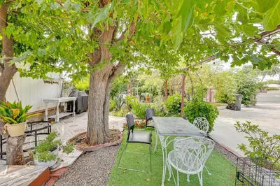 a patio with a table and chairs under a tree at Fullerton Home Base Easy Access to Dtwn and CSUF! in Fullerton
