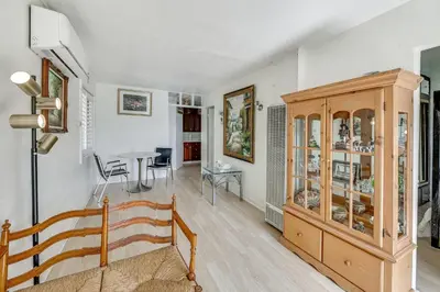 a living room with a wooden cabinet and a table at Fullerton Home Base Easy Access to Dtwn and CSUF! in Fullerton