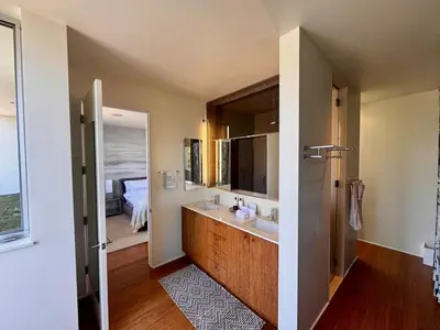 a bathroom with a sink and a large mirror at Venice Walk Street Retreat Jacuzzi and Lemon Tree in Los Angeles