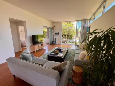 a living room with a couch and a table at Venice Walk Street Retreat Jacuzzi and Lemon Tree in Los Angeles