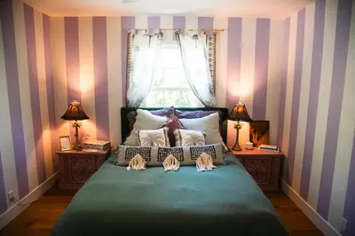 a bedroom with a large bed with two night stands at Casa Cleopatra Bold Design, Pool and Privacy in Los Angeles