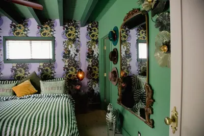 a bedroom with a bed and a mirror at Casa Cleopatra Bold Design, Pool and Privacy in Los Angeles