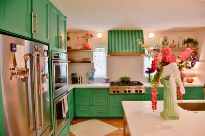 a green kitchen with green cabinets and a refrigerator at Casa Cleopatra Bold Design, Pool and Privacy in Los Angeles