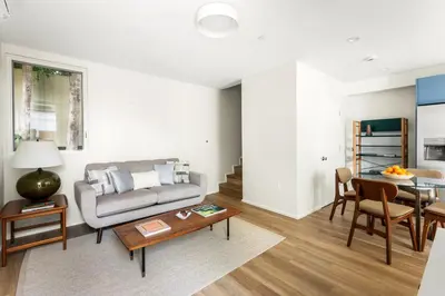a living room with a couch and a table at Modern Mar Vista Hideaway New TwoStory ADU in Los Angeles