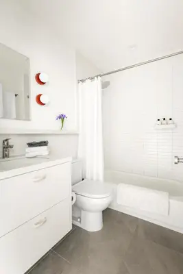 a white bathroom with a toilet and a sink at Modern Mar Vista Hideaway New TwoStory ADU in Los Angeles