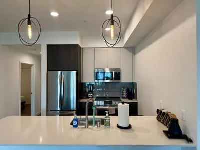 a kitchen with a counter top and a refrigerator at Westwood Penthouse 3 Bedroom 2 Bath w Gym, Balcony, Parking in Los Angeles