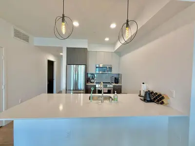 a kitchen with a large white island in a room at Westwood Penthouse 3 Bedroom 2 Bath w Gym, Balcony, Parking in Los Angeles