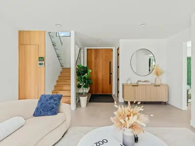 a living room with a couch and a mirror at Casa Leona in Los Angeles