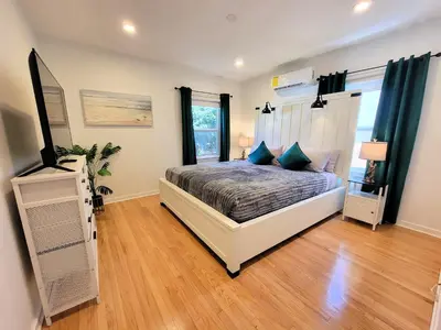 a bedroom with a bed and a television in it at Private and large 2 bedroom house with Pool table, backyard and office near attractions in Los Angeles