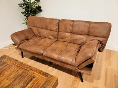 a brown leather couch sitting in a living room at Private and large 2 bedroom house with Pool table, backyard and office near attractions in Los Angeles