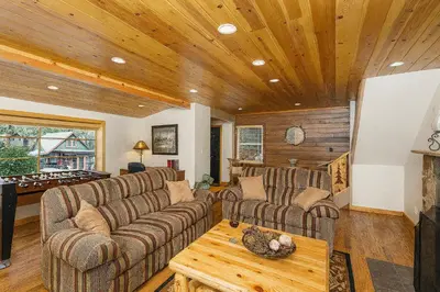a living room with couches and a pool table at Cozy Cabin with Large Backyard Near Lake, Village and Snow Summit in Big Bear Lake