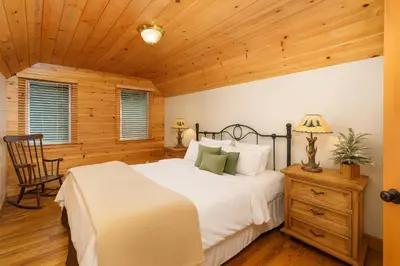 a bedroom with a bed and a wooden ceiling at Cozy Cabin with Large Backyard Near Lake, Village and Snow Summit in Big Bear Lake