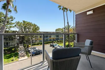 a balcony with chairs and a view of a parking lot at Moonstone Quiet Retreat Marina Side Garden view in Los Angeles