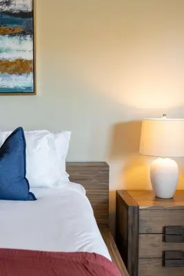 a bedroom with a bed and a table with a lamp at Moonstone Quiet Retreat Marina Side Garden view in Los Angeles