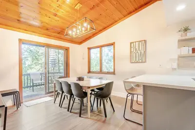a kitchen and dining room with a table and chairs at Sleeps 10 Cozy Modern Cabin 4 bedroom 3 bath 2400 sq ft 3 story Updated Quiet cabin in Crestline